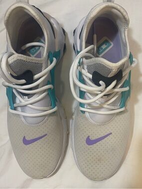 Nike White Athletic Shoes with Tealy and Purple Swoosh Accents
READ NOTES BELOW